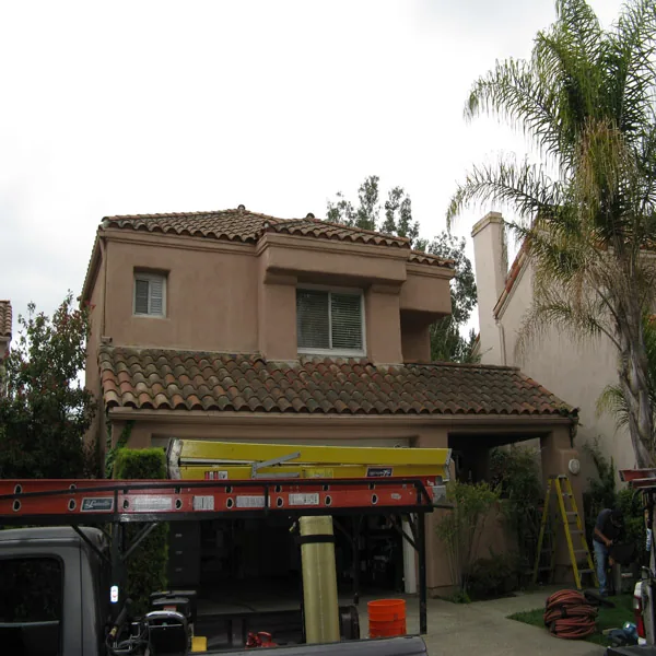 Two-story tile-roof house before cleaning