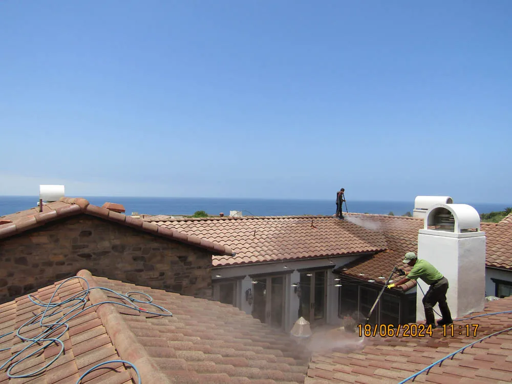 Technician cleaning terra-cotta roof tile