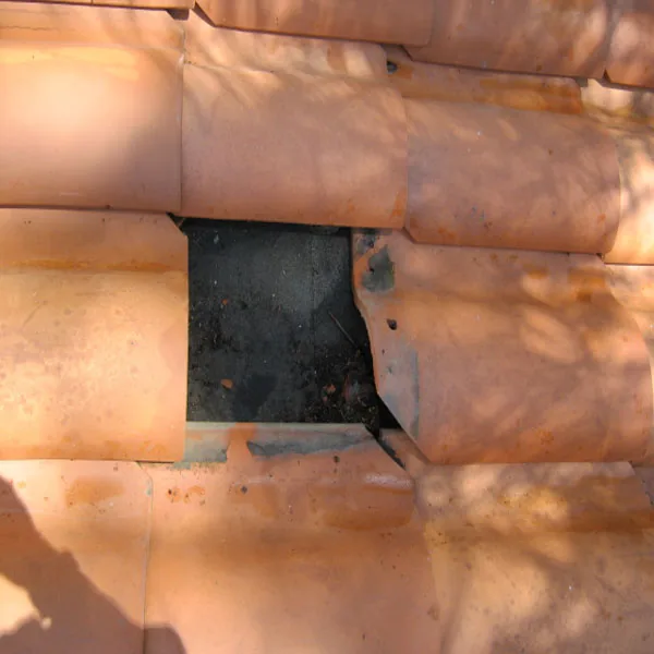 Open section in terra-cotta roof tile before replacement