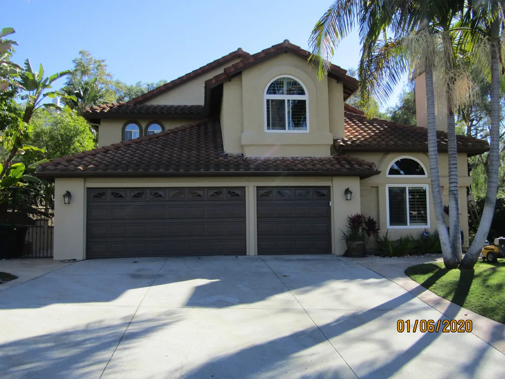 Tile-roof home among mature trees before cleaning used as a companion foothill view.
